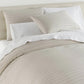 Houndstooth Percale Sleeping Shams Greige on bed