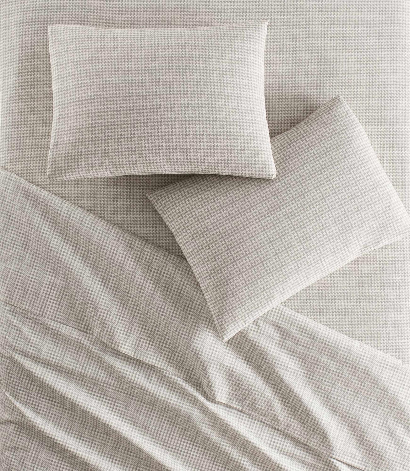 Houndstooth Percale Flat Sheet and shams on bed Greige