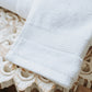 Liam Hand Towel In White On A White Table