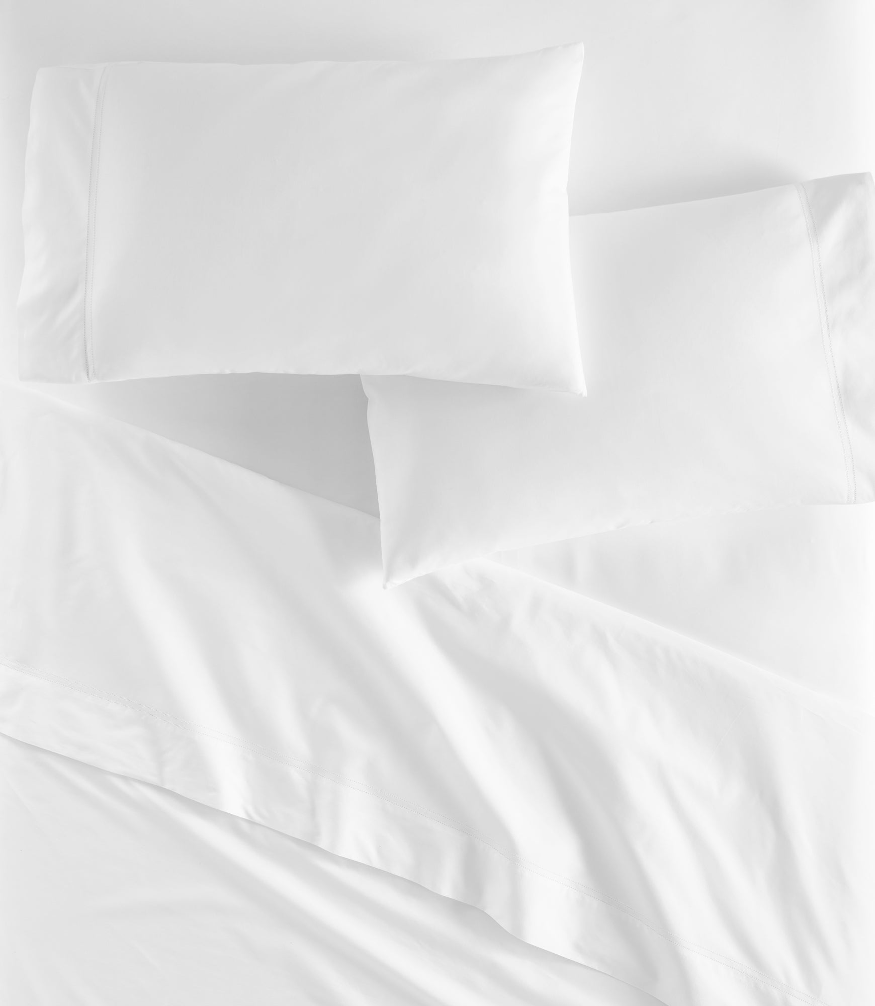 Lyric Percale Fitted Sheet on bed White