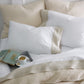 Linen cuff percale flat sheets and pillow cases with a book and coffee cup