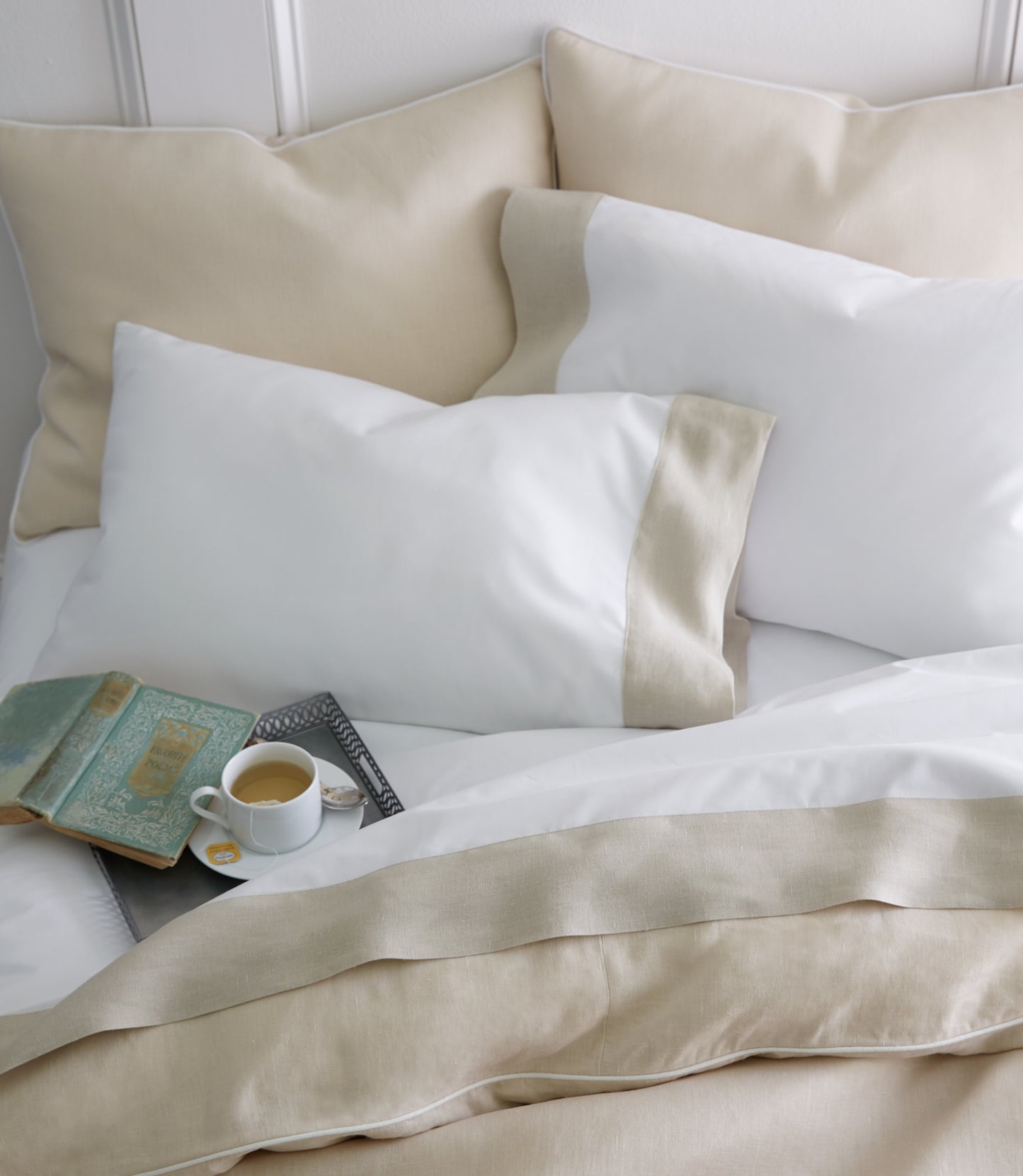 Linen cuff percale flat sheets and pillow cases with a book and coffee cup