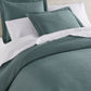 Oxford Matelassé Shams on bed Pine