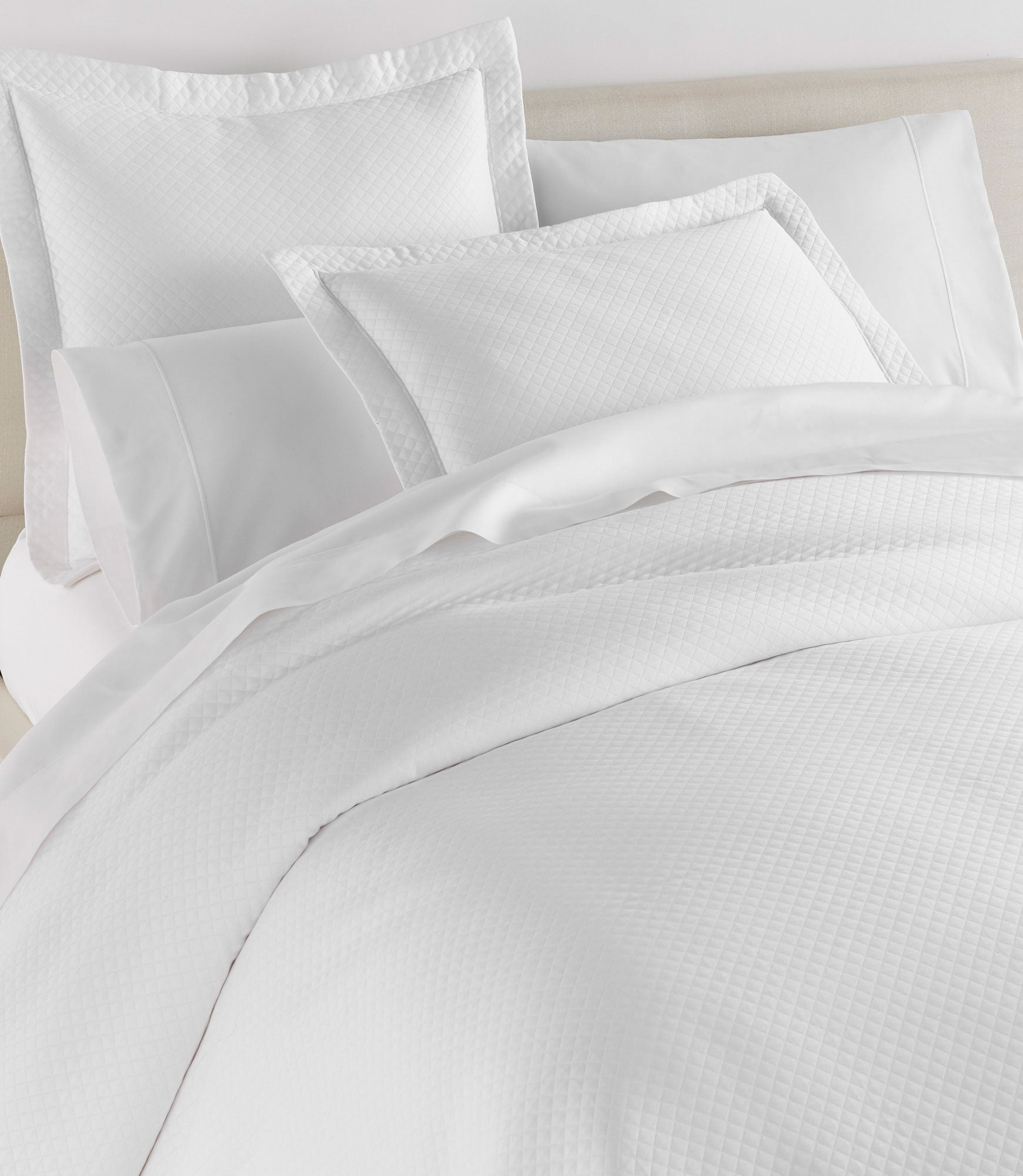 Oxford Matelassé Shams on bed White