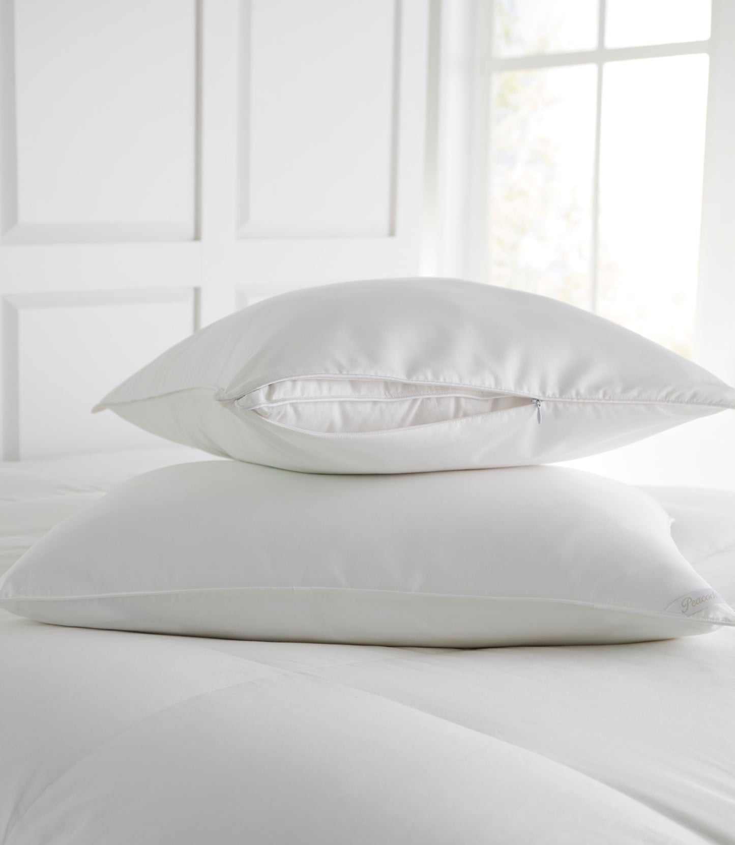 Stacked Pillow Protectors on bed White