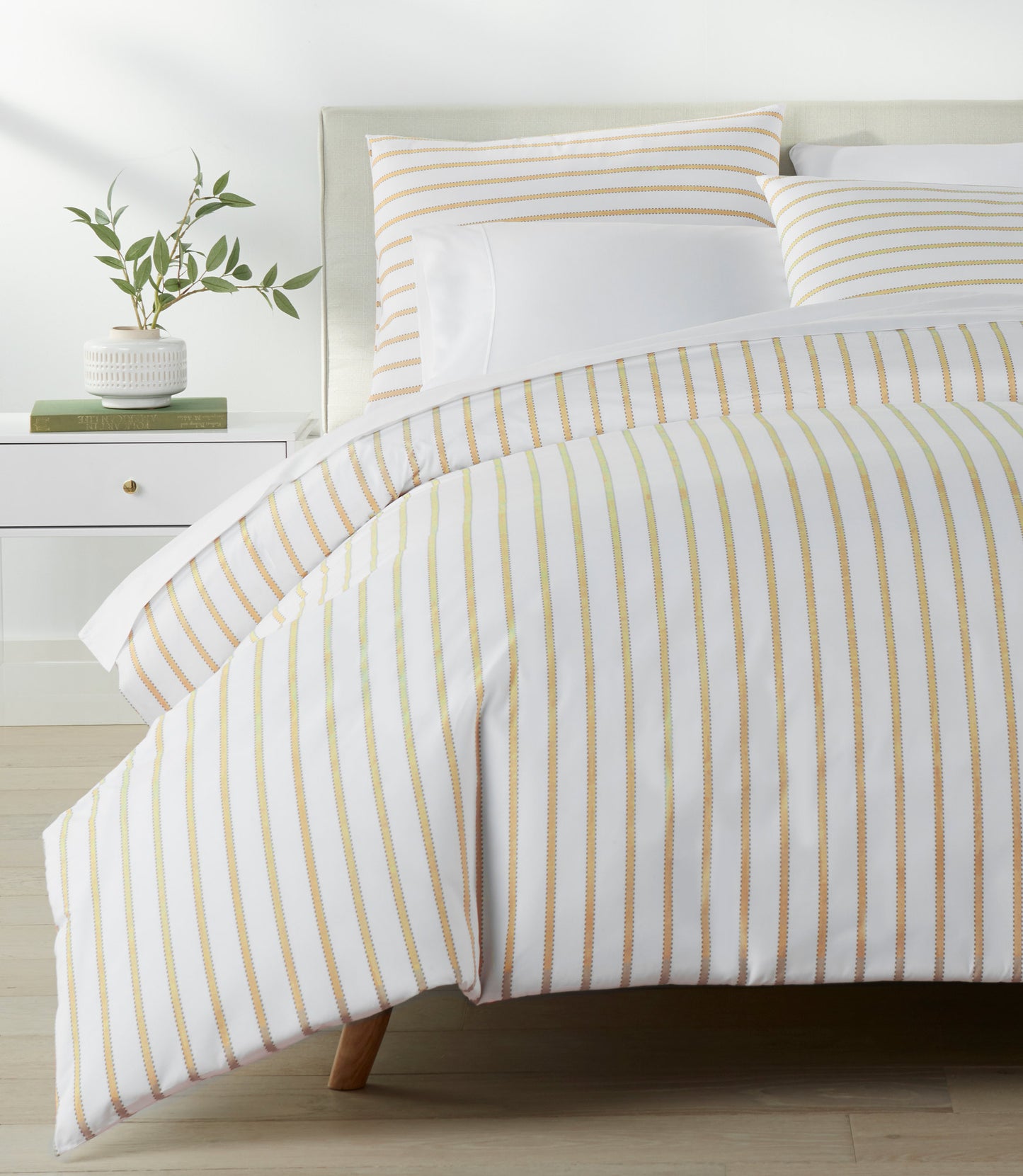 ribbon stripe percale Honey duvet cover on a bed in bedroom