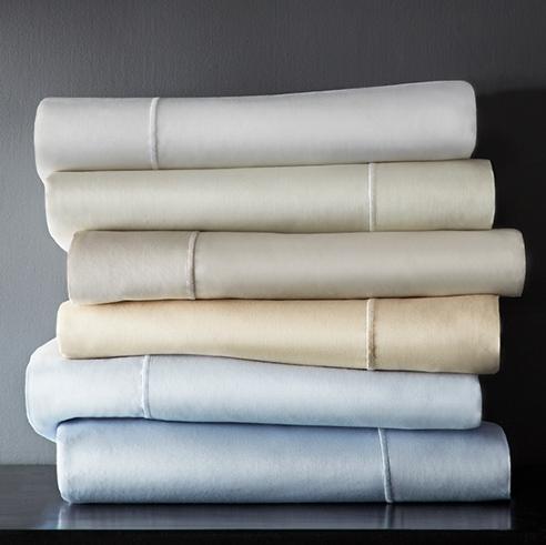 Stack of Soprano neutral color sheet sets on table top