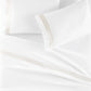 Soprano Trim Sateen Pillowcases on bed Platinum